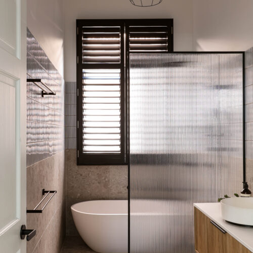 Fluted glass shower screen with matt black frame in Yarraville home