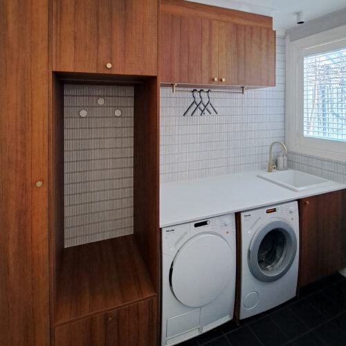 Timber laundry cabinetry with under bench washing machine and dryer
