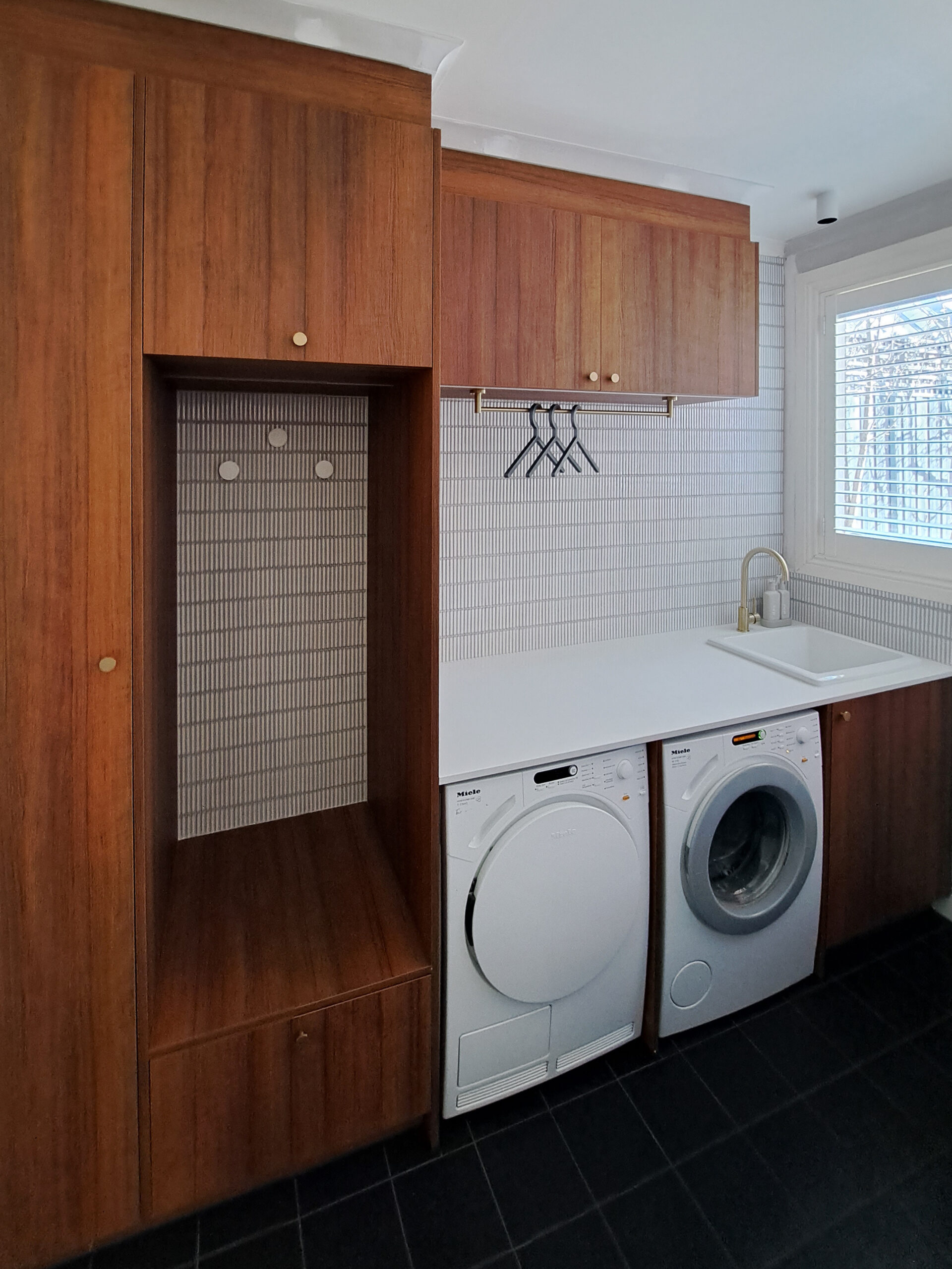 Timber laundry cabinetry with under bench washing machine and dryer