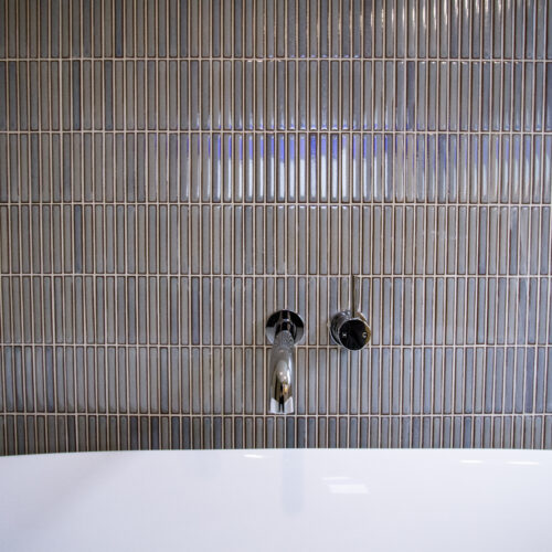 Feature wall behind a freestanding bath using Yohan Border tile YB21