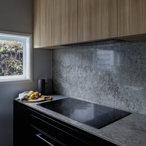 Induction cooktop with Turbine Grey stone benchtop and splashback