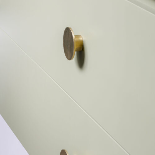 Brushed brass handle detail on a custom green vanity unit