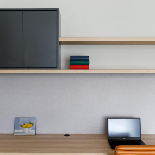Study joinery with a timber desktop & shelves and matt black cabinetry