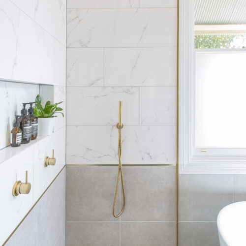 Williamstown bathroom renovation with carrara marble wall tiles and Astra Walker brass tapware