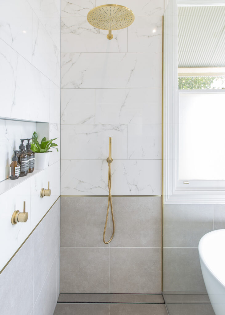 Williamstown bathroom renovation with carrara marble wall tiles and Astra Walker brass tapware