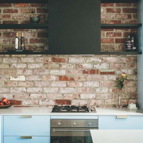 Kitchen with brick wall splashback
